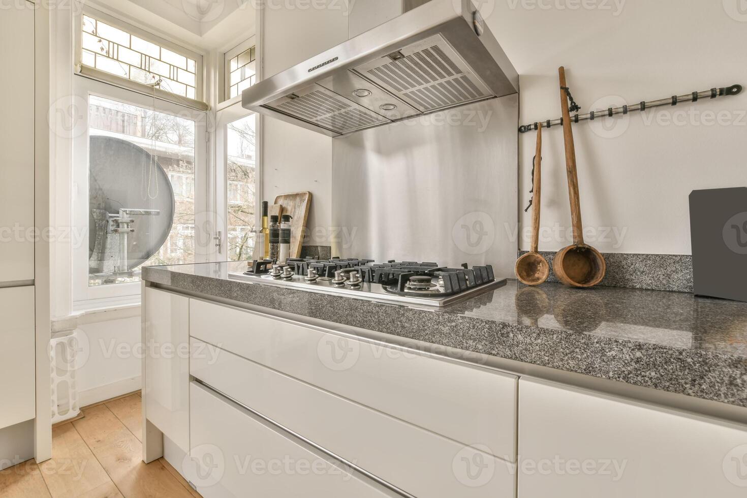 A kitchen with a stove and a sink photo