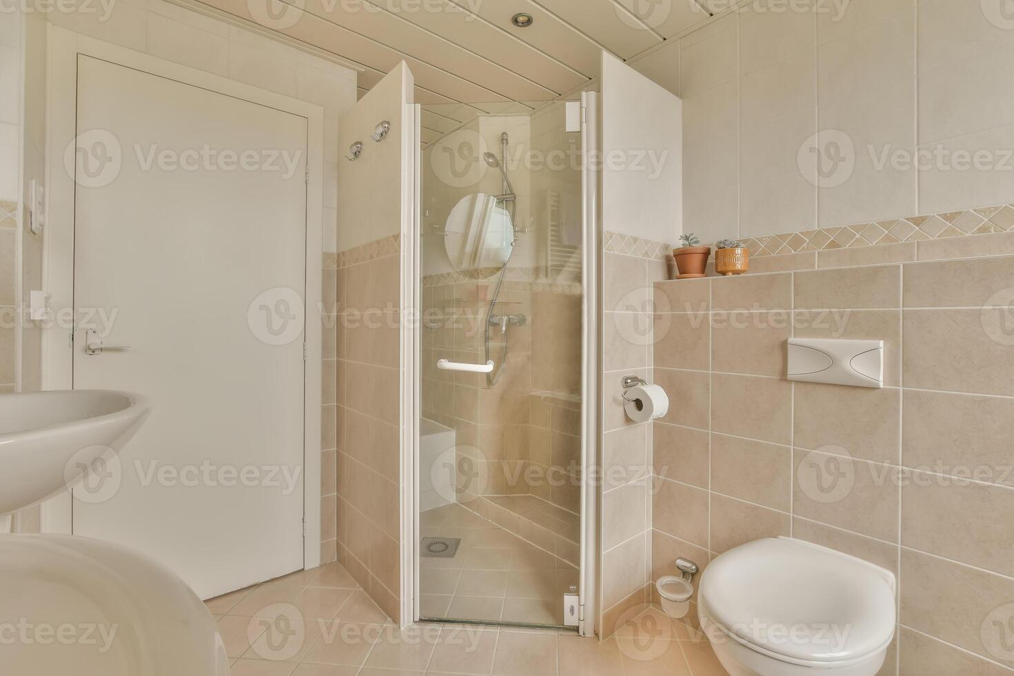 A bathroom with a toilet, sink and shower photo