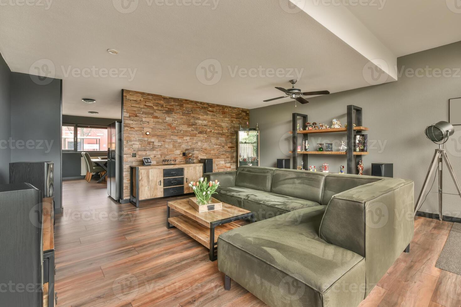 A living room with a couch, television and a brick wall photo
