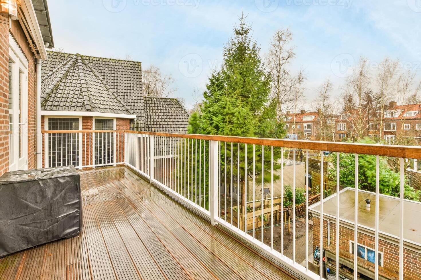 A balcony with a table and chairs on it photo
