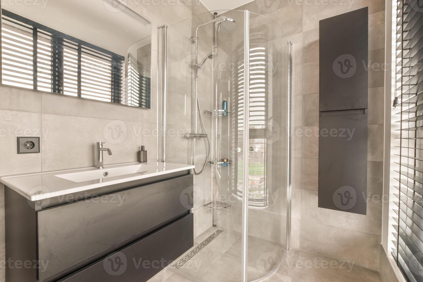 A bathroom with a glass shower stall and a sink photo