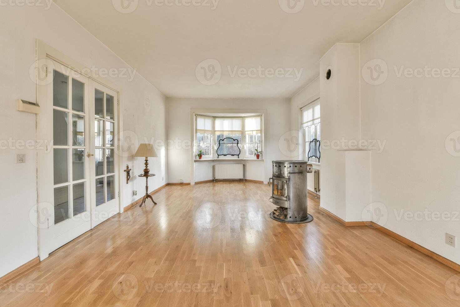 A room with wooden floors and white walls photo