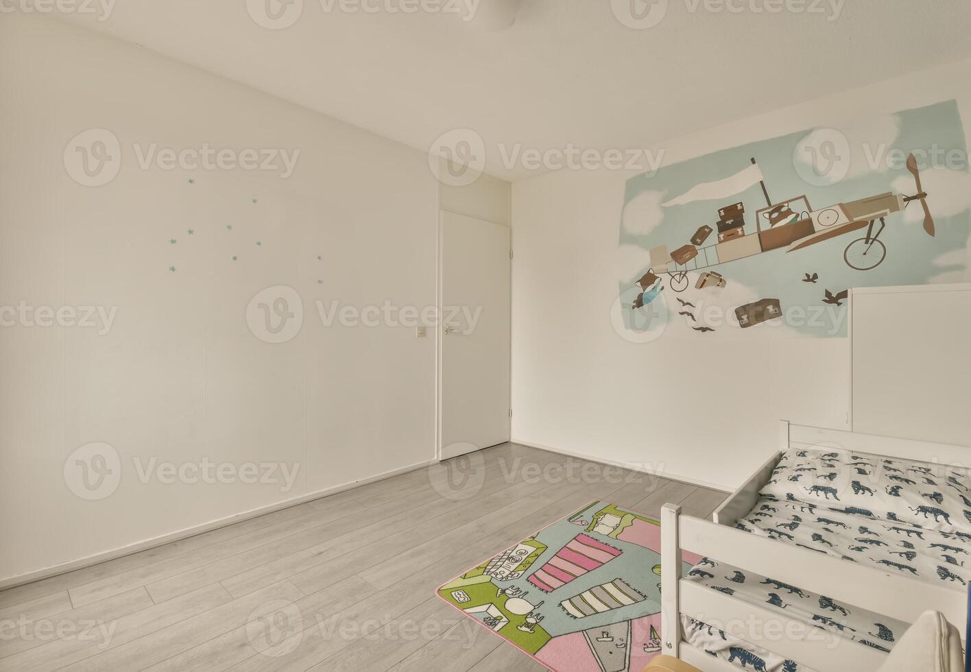 A small bedroom with a bed and a wall mural photo