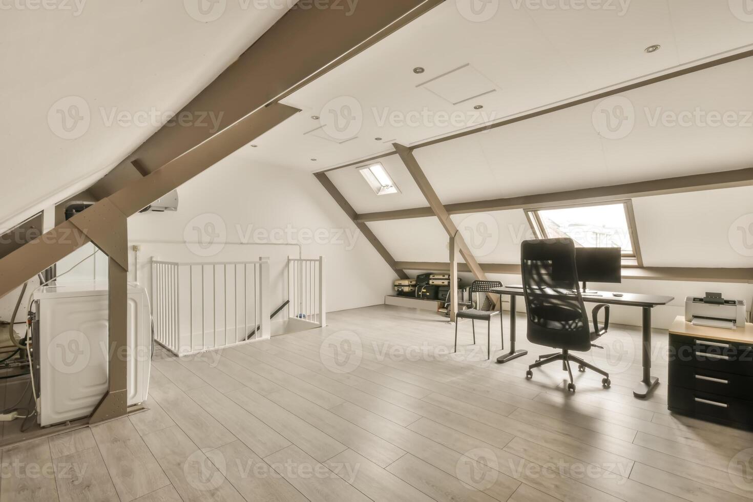 An office with a desk and chair in an attic photo