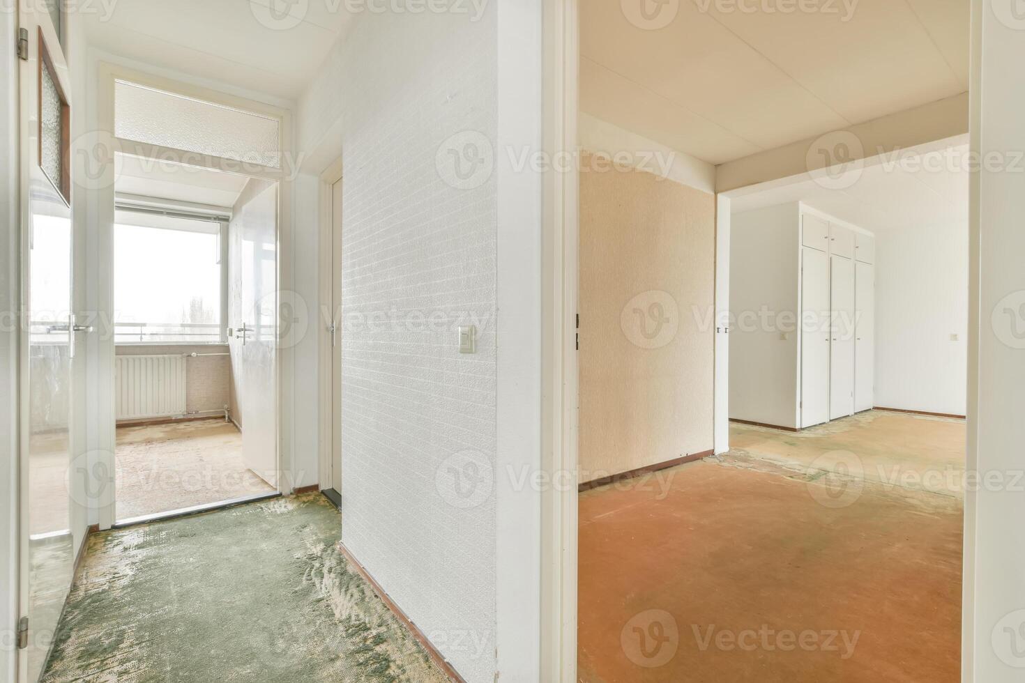 An empty room with a door and a carpet photo