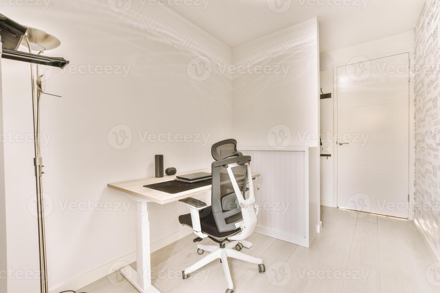 A home office with a desk and chair photo