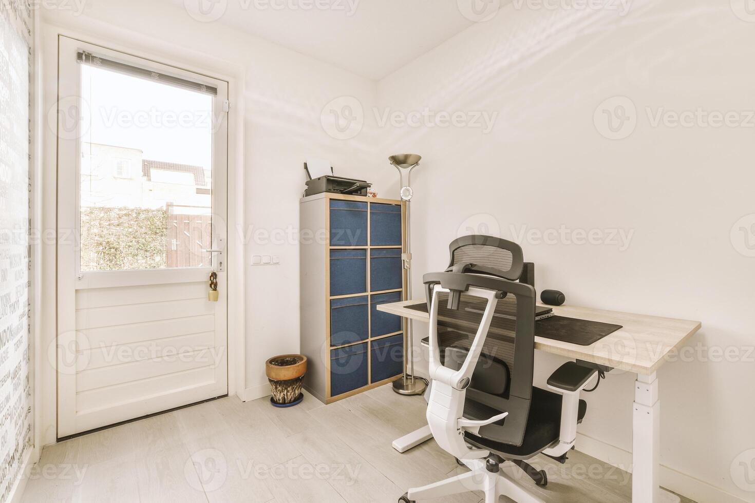 A white desk with a chair and a computer photo