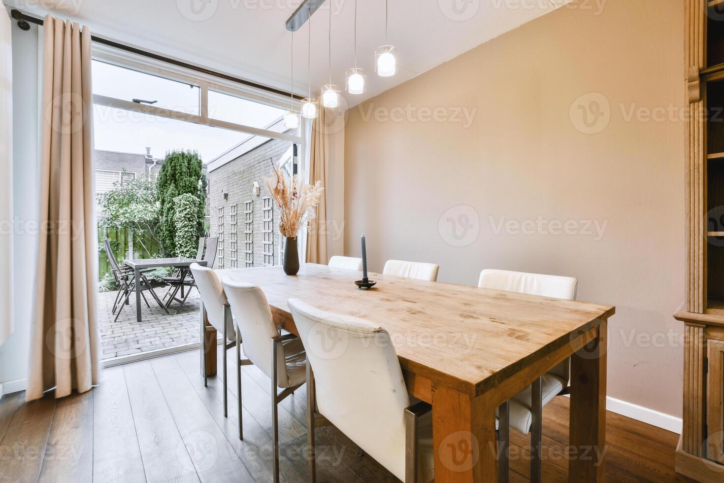 A dining room with a wooden table and chairs photo