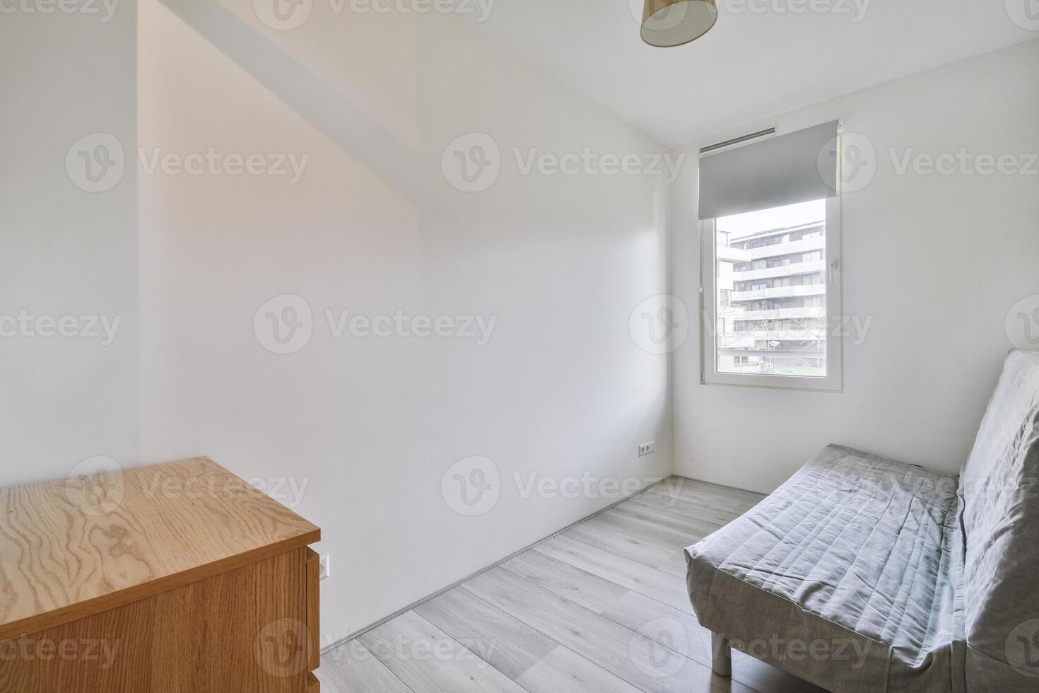 A small room with a bed and a window photo