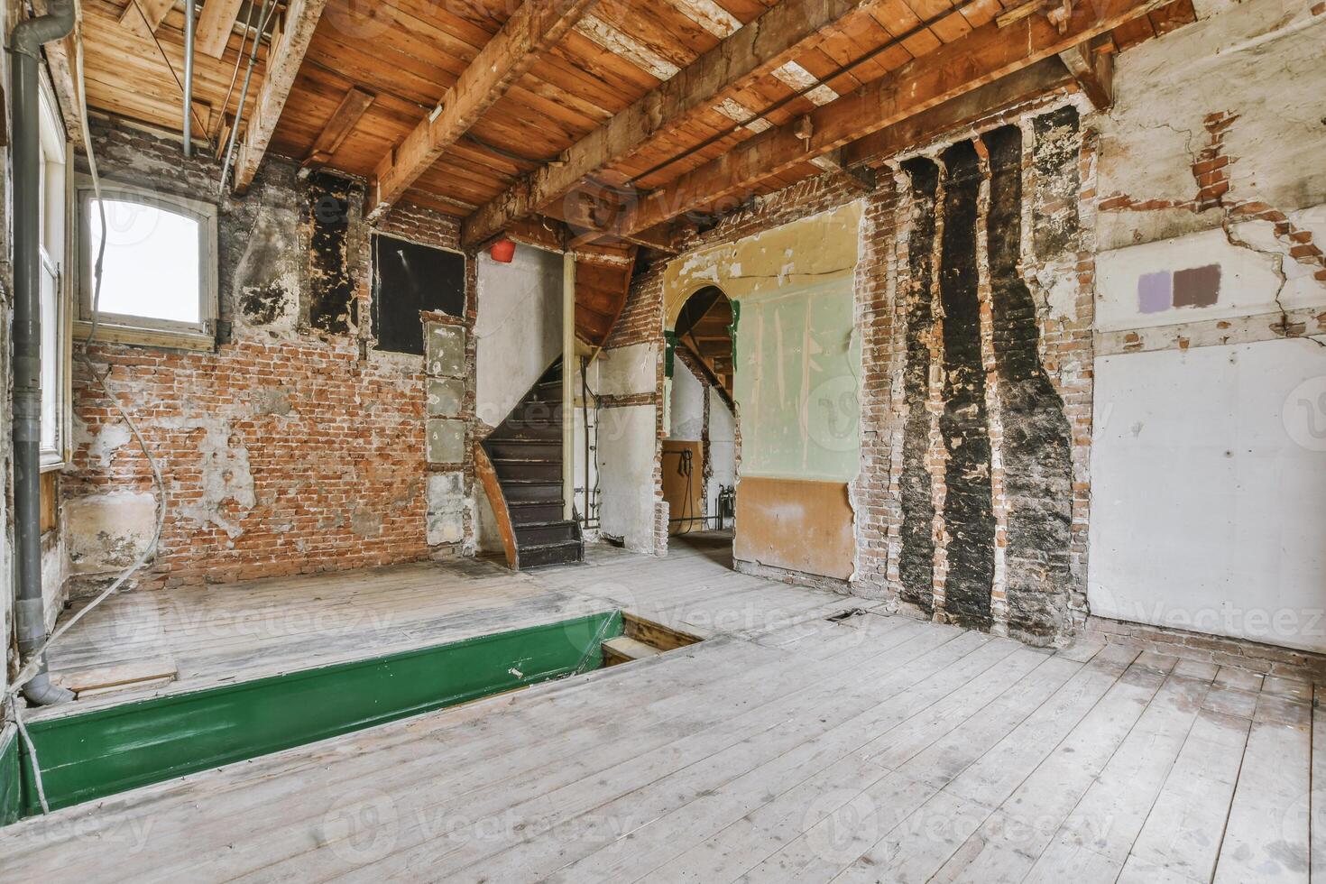 An empty room with exposed brick walls and a pool table photo