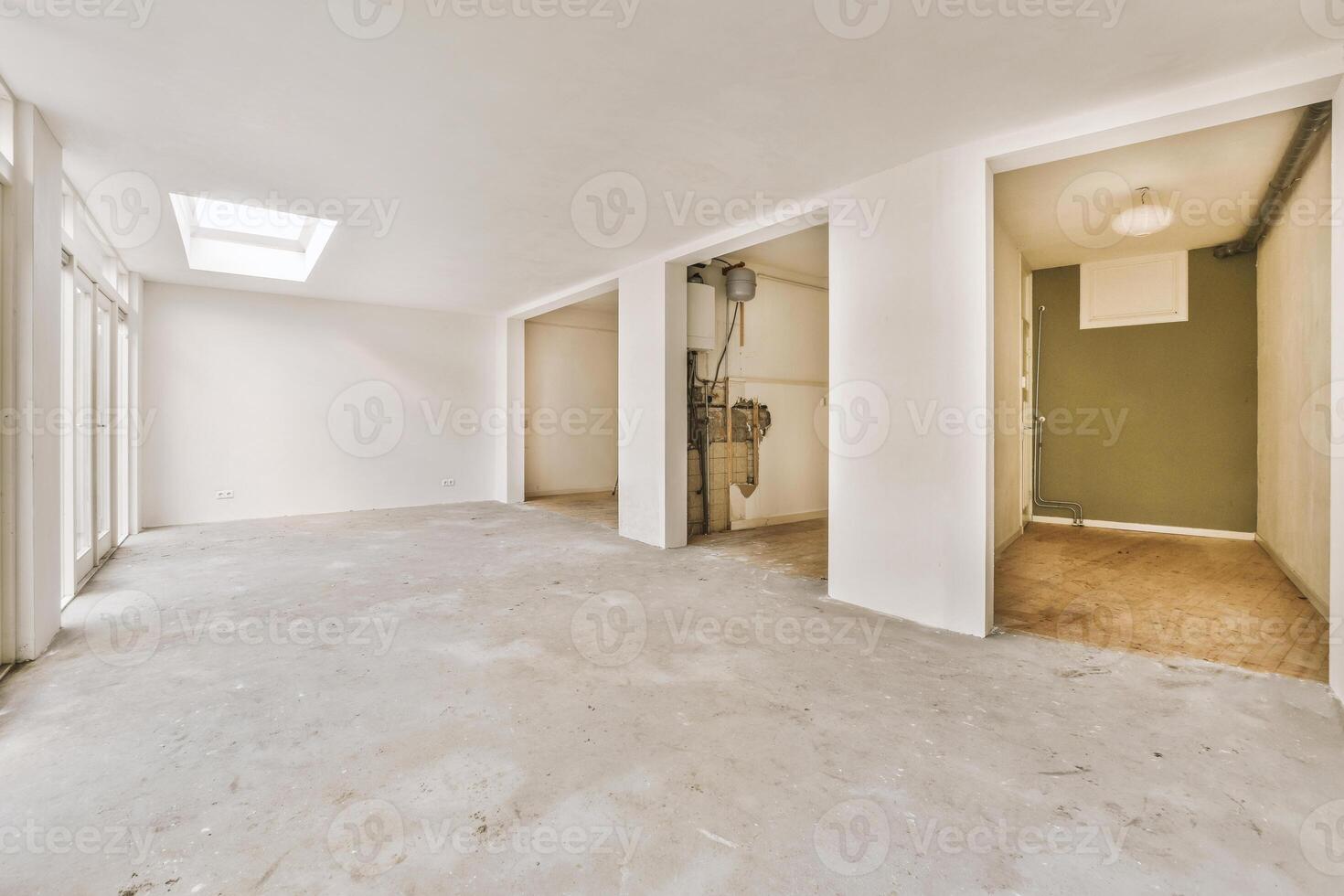 An empty room with a skylight and a door photo