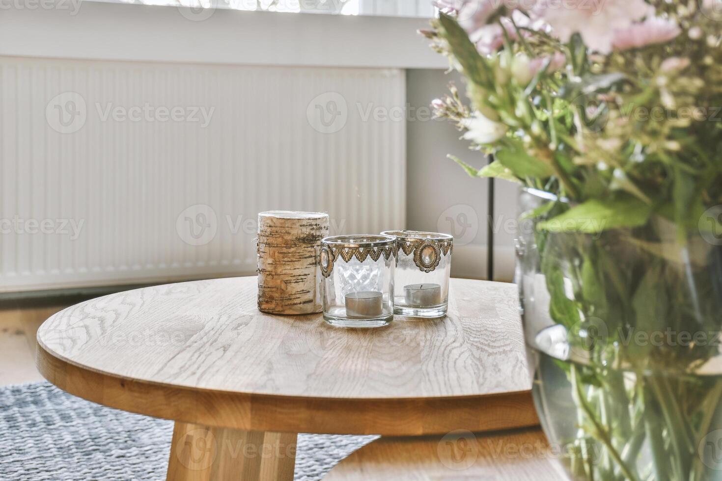 A table with flowers and a vase on it photo