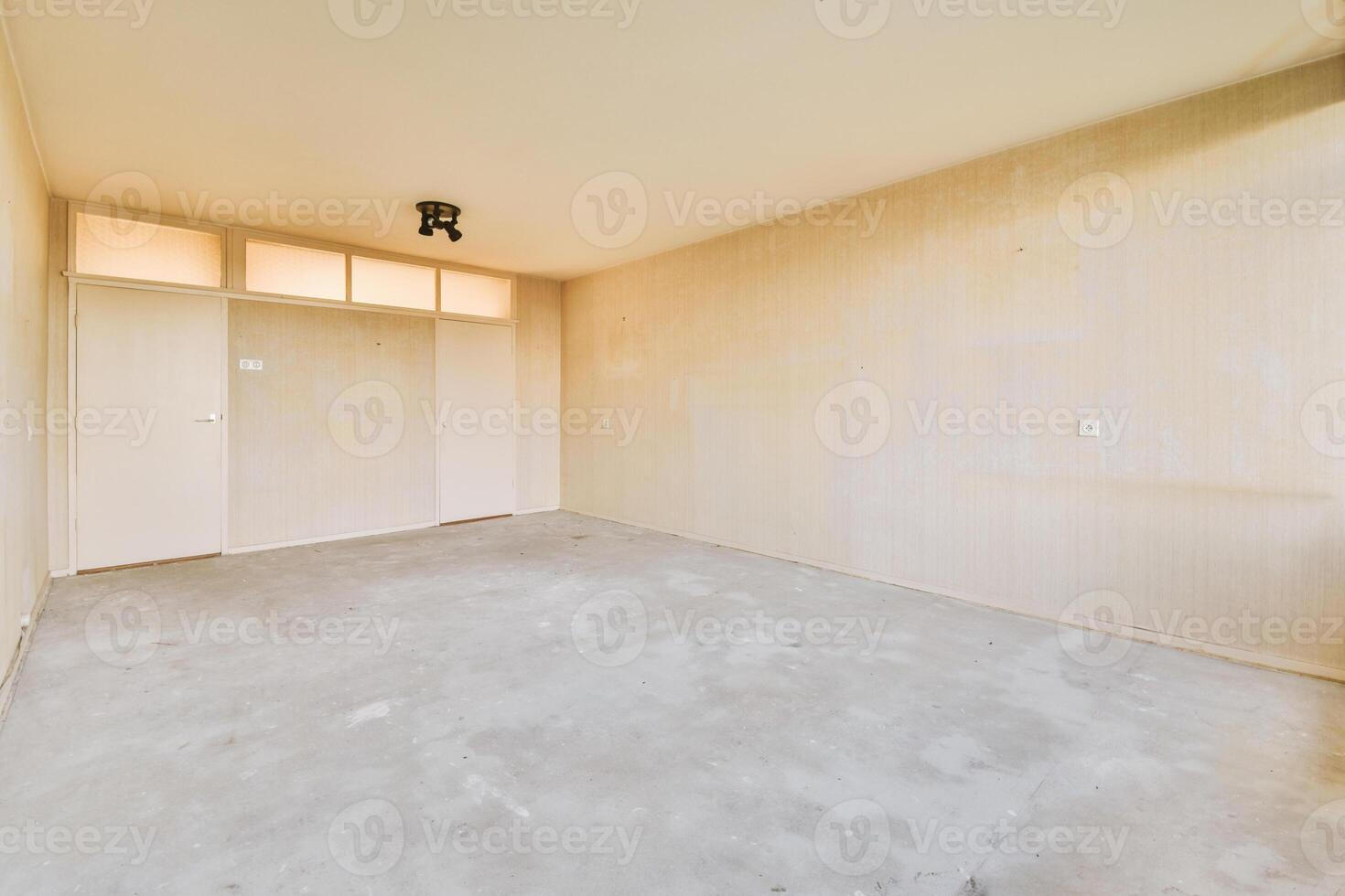 Empty room with a light fixture and a door photo