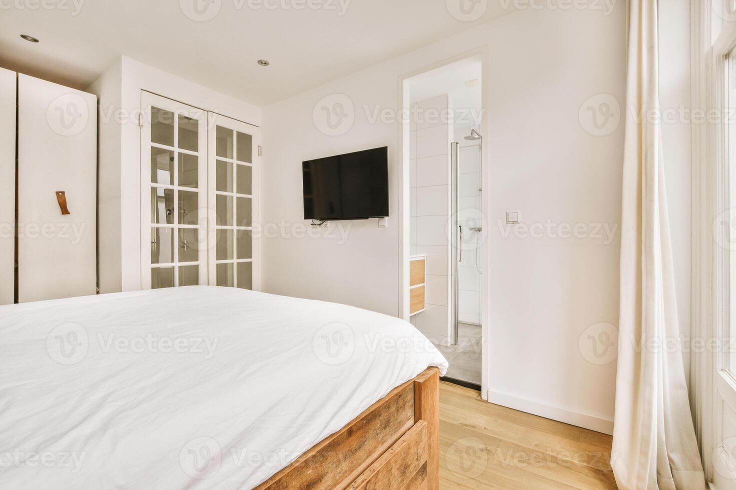 A bedroom with a bed, television and closet photo