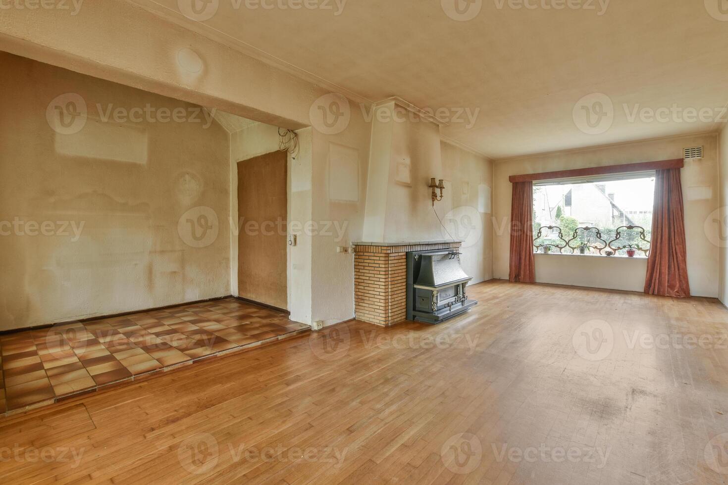 Empty living room with wood floors and a fireplace photo