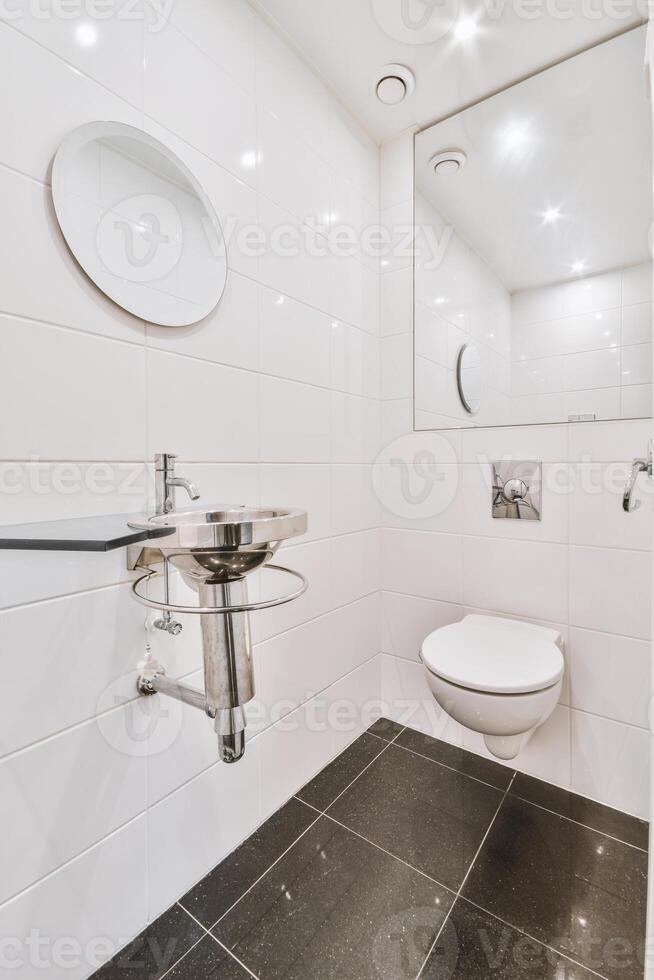 A white bathroom with a sink and mirror photo