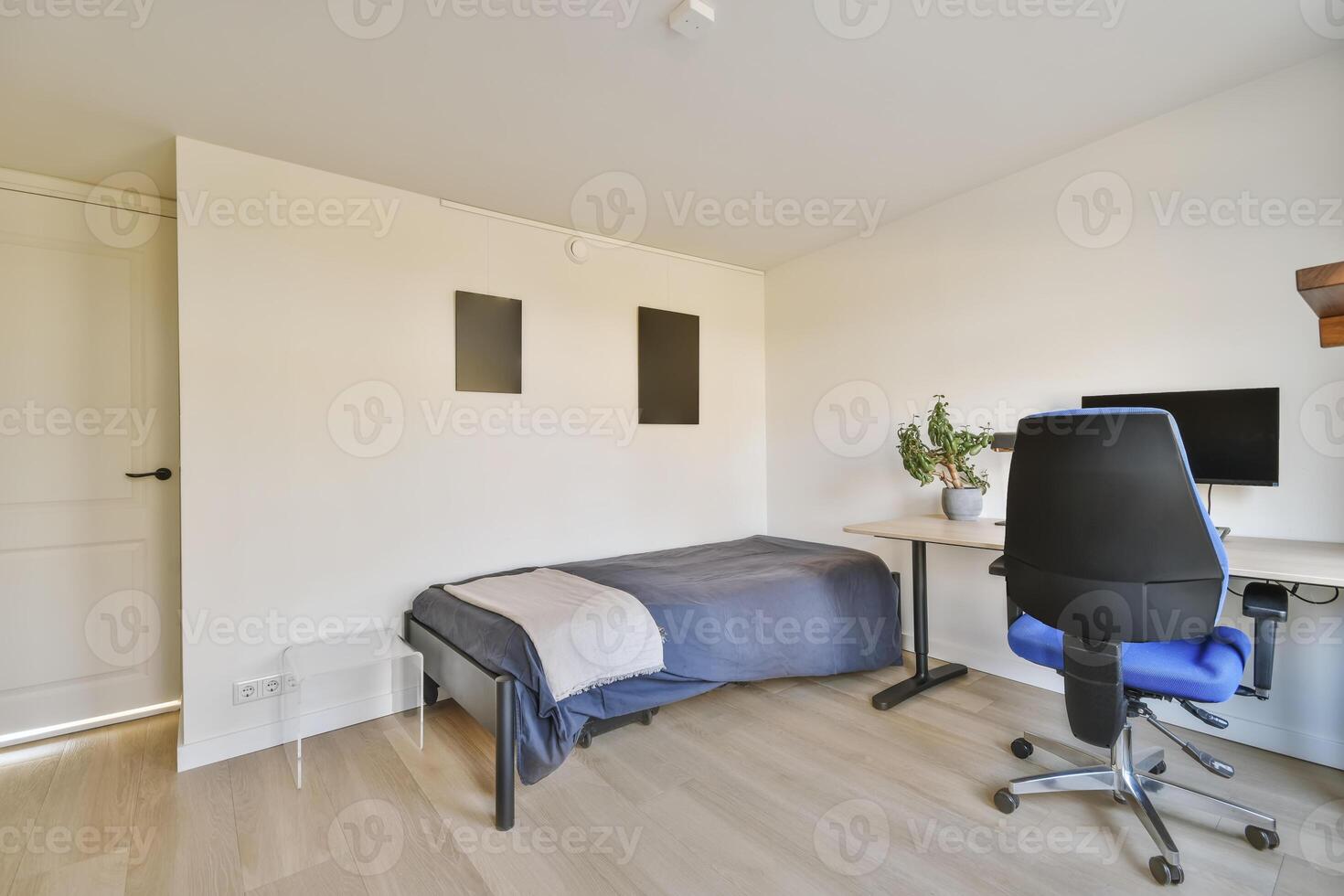 A bedroom with a desk and chair in it photo