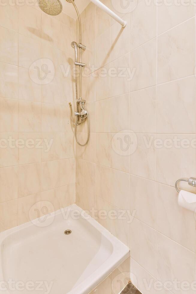 A shower with a shower head photo