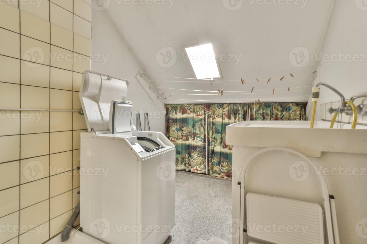 A bathroom with a washing machine and a sink photo