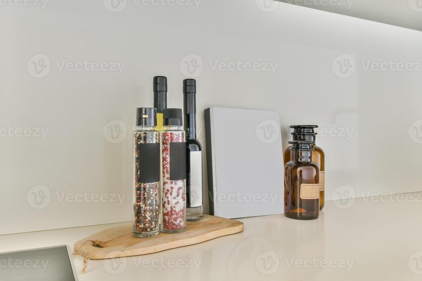 A white counter with bottles and a book on it photo