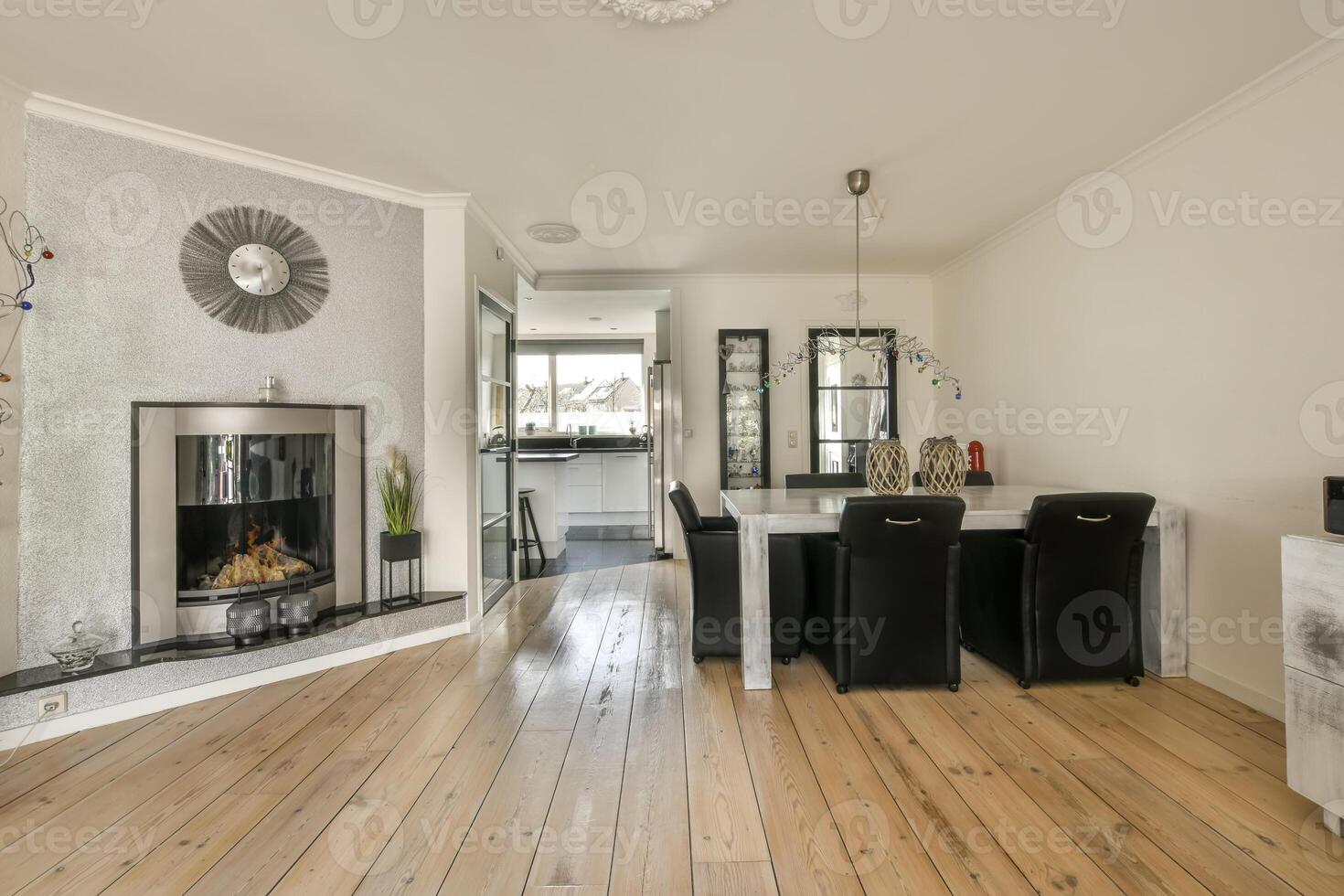 A living room with a fireplace and a dining table photo
