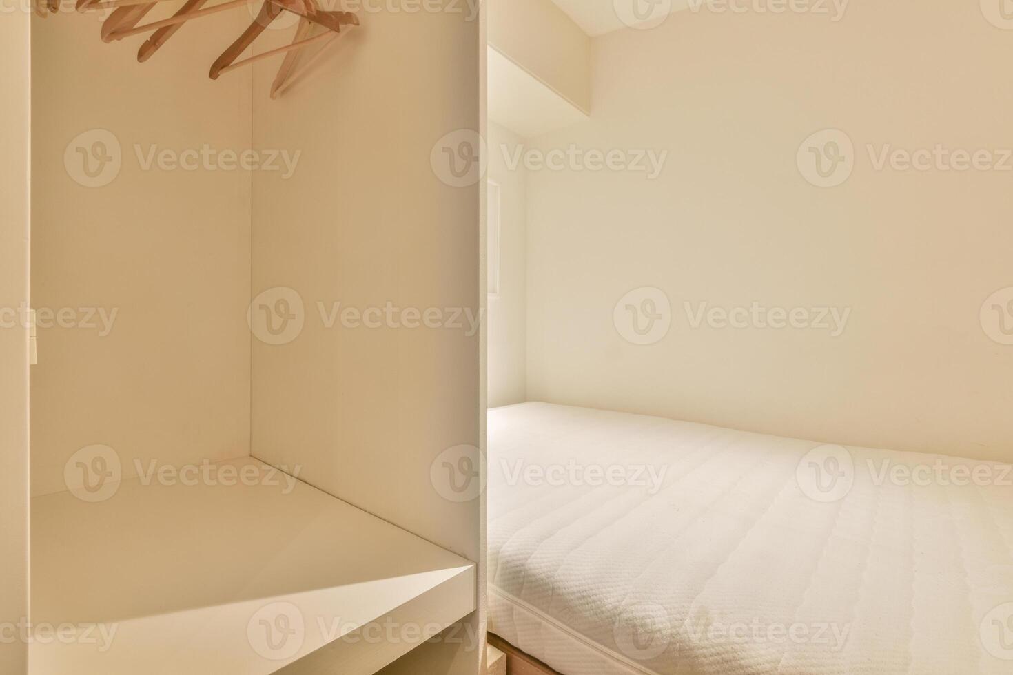 A small bedroom with a closet and a bed photo