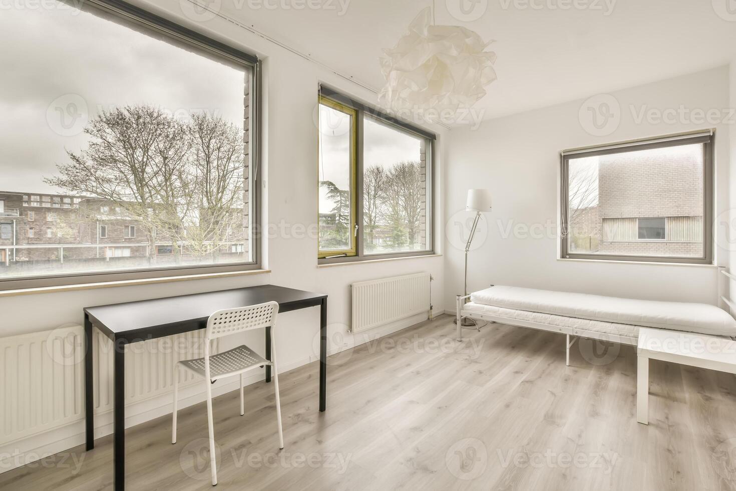 A bedroom with a desk and a window photo