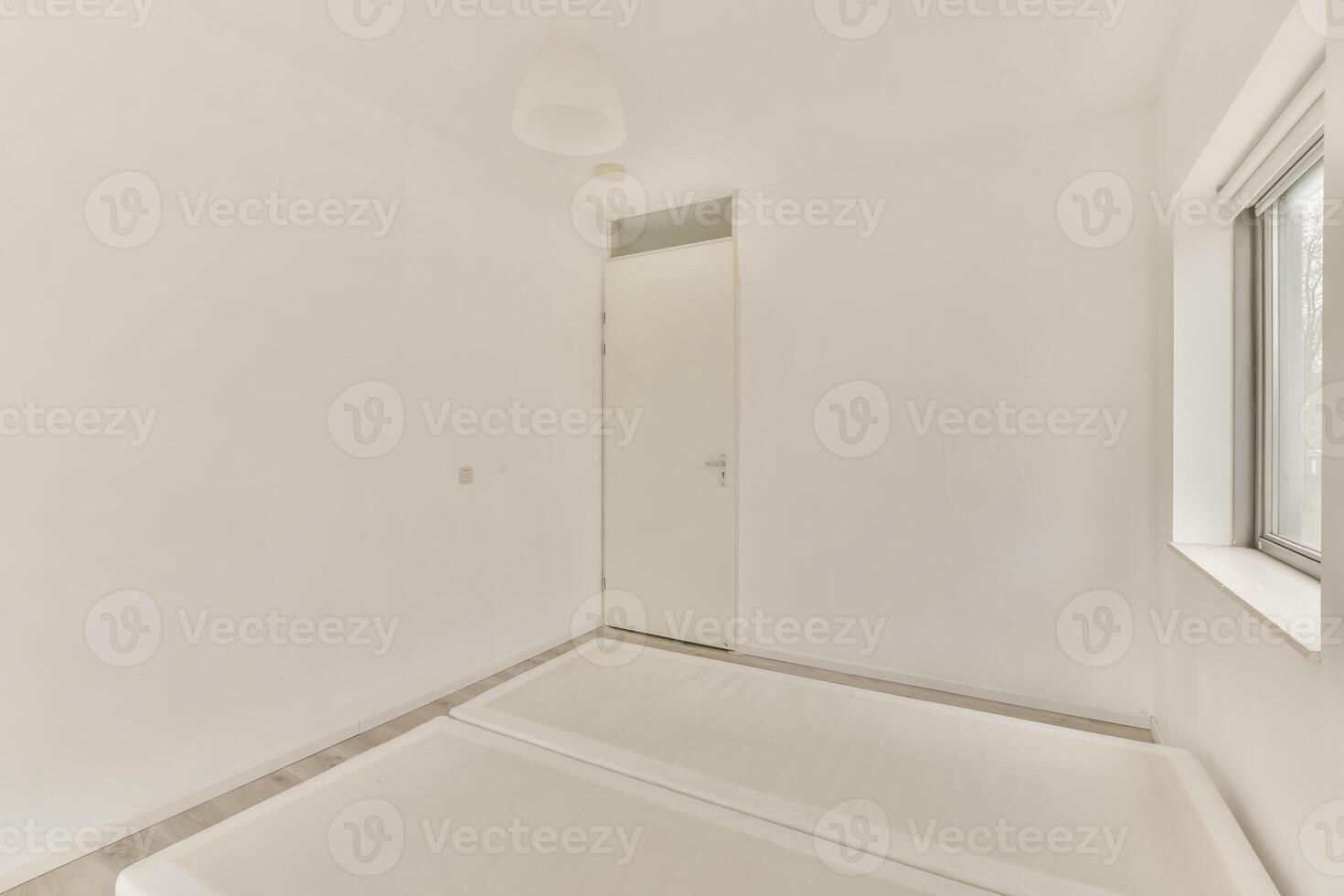 A white room with a bed and a window photo