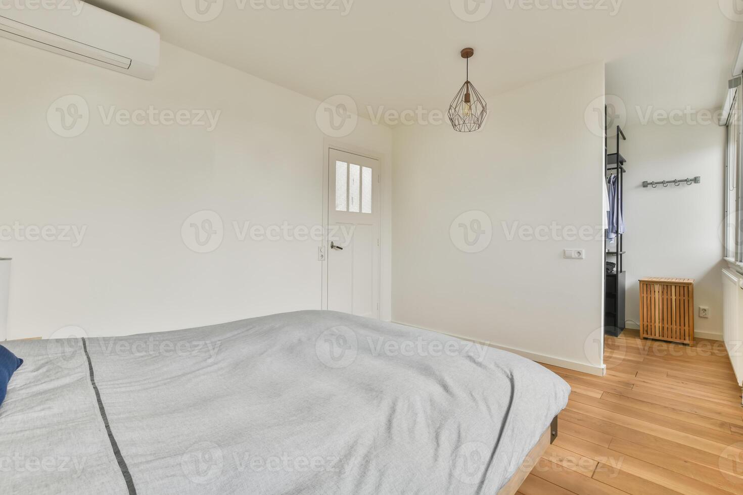 A bedroom with a bed, a dresser and a window photo