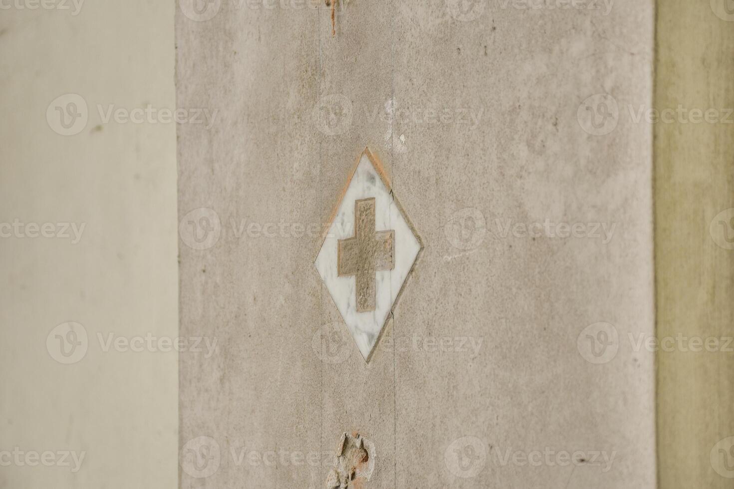 A white cross on a wall in a building photo