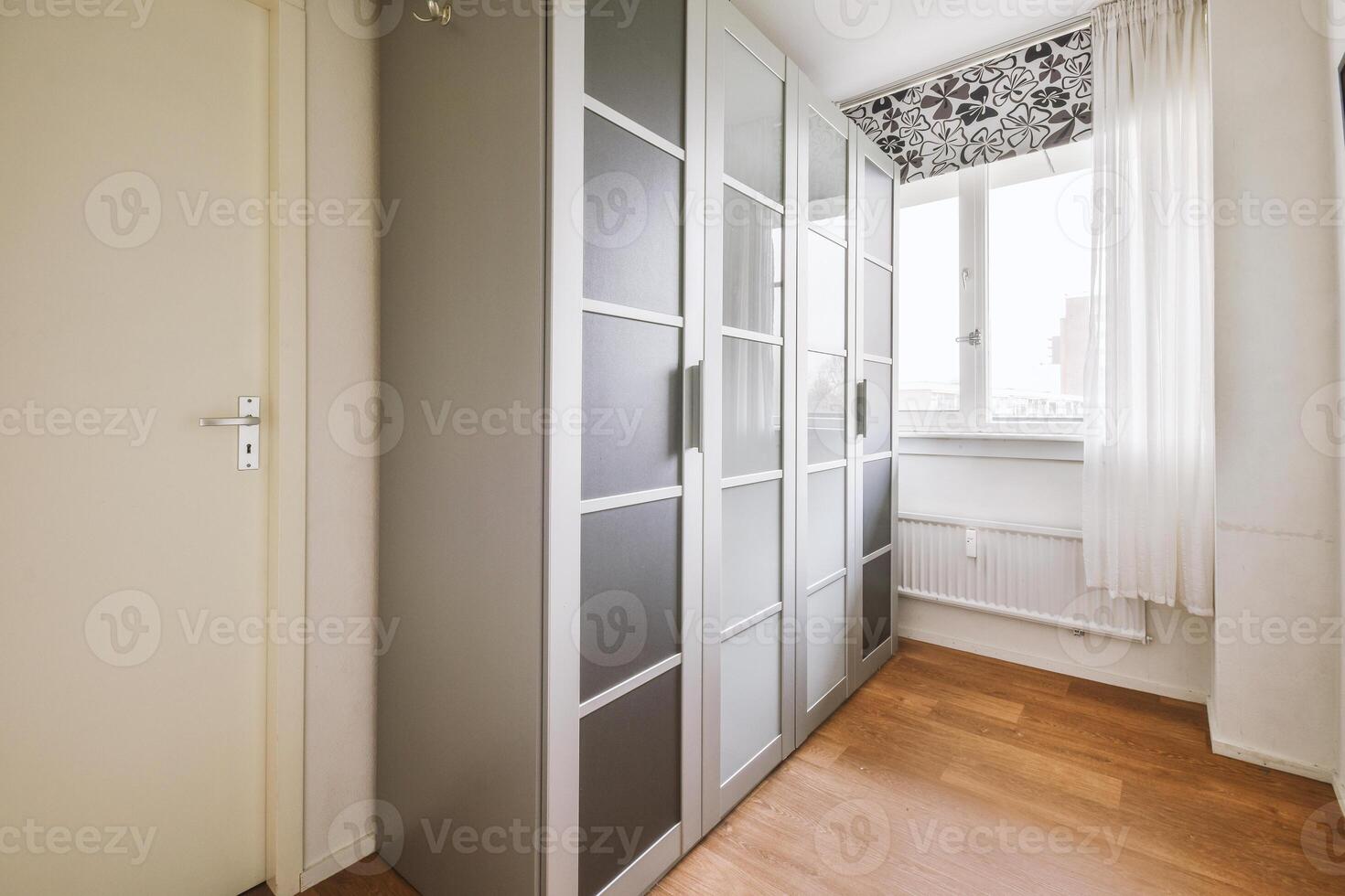 A room with a door and a cabinet with doors photo