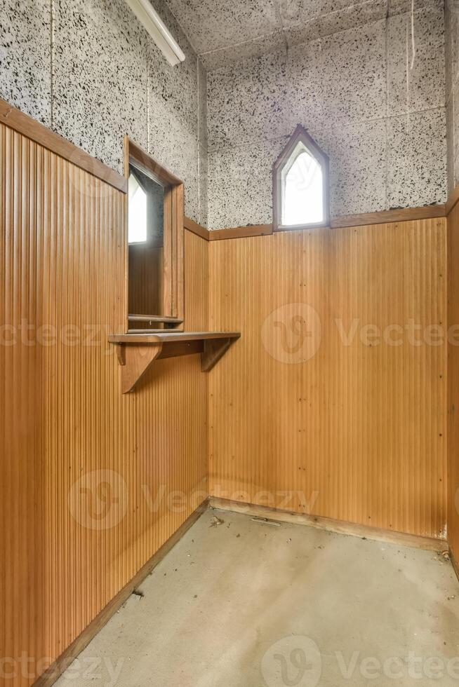 An empty room with a wooden wall and a window photo