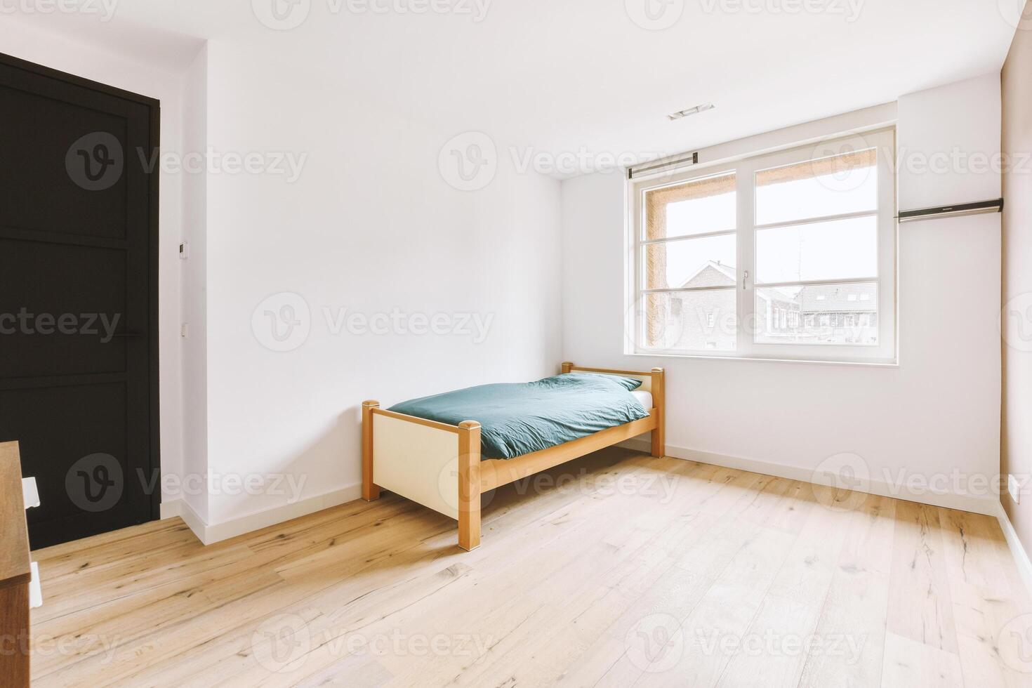 A bedroom with a bed and a window photo