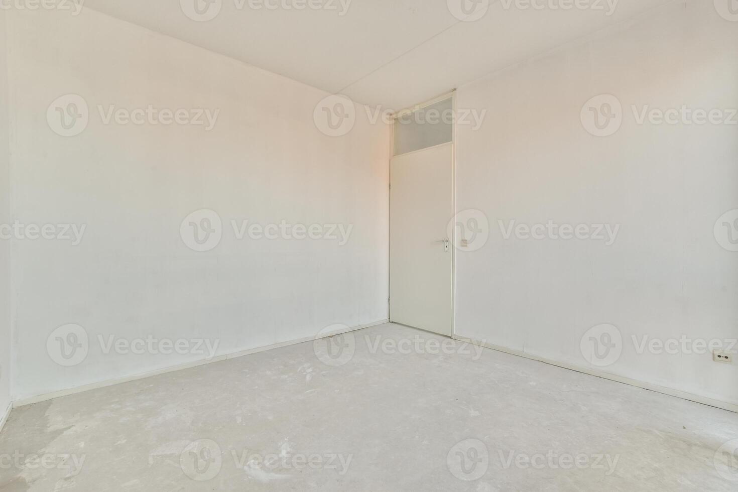 An empty room with white walls and a door photo