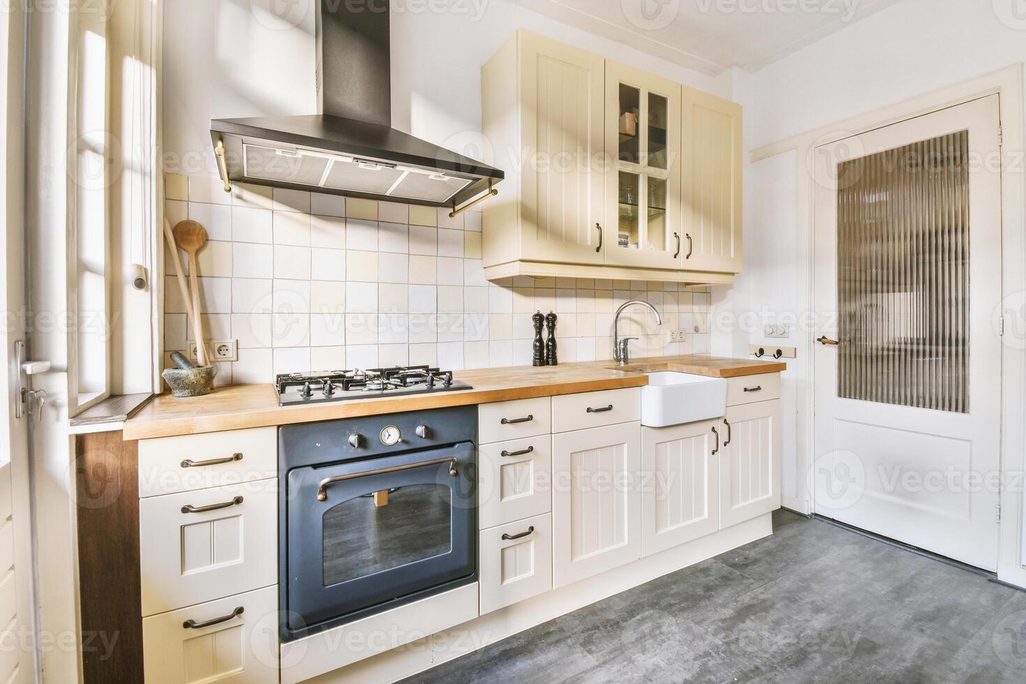 A kitchen with a stove, oven and sink photo