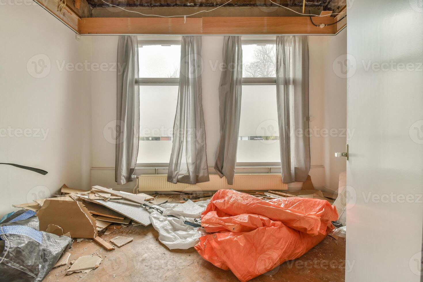 A room with a pile of debris and a window photo