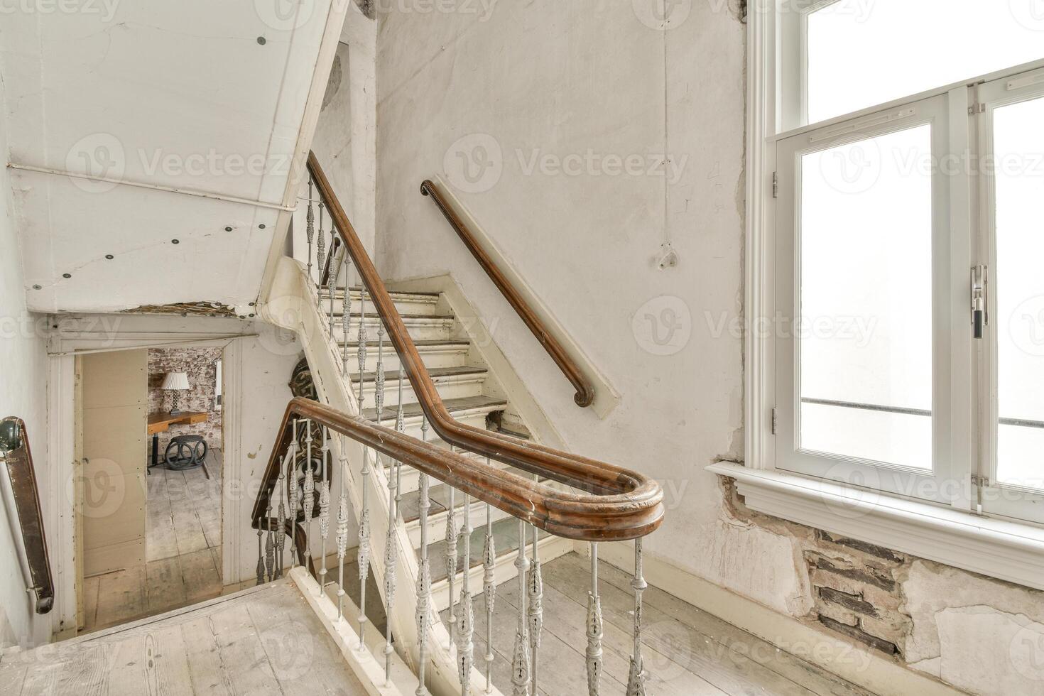 A staircase in an old house with a wooden railing photo