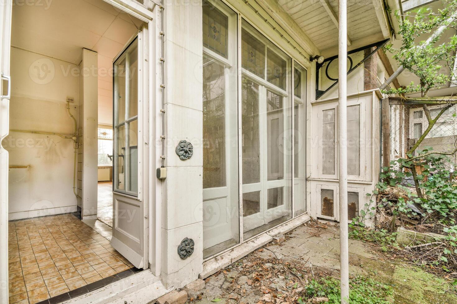 An old house with a door and windows open photo