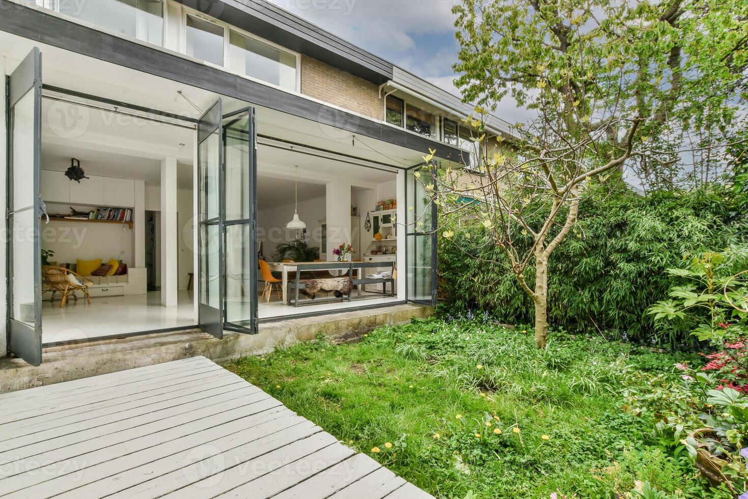A modern home with a patio and a garden photo