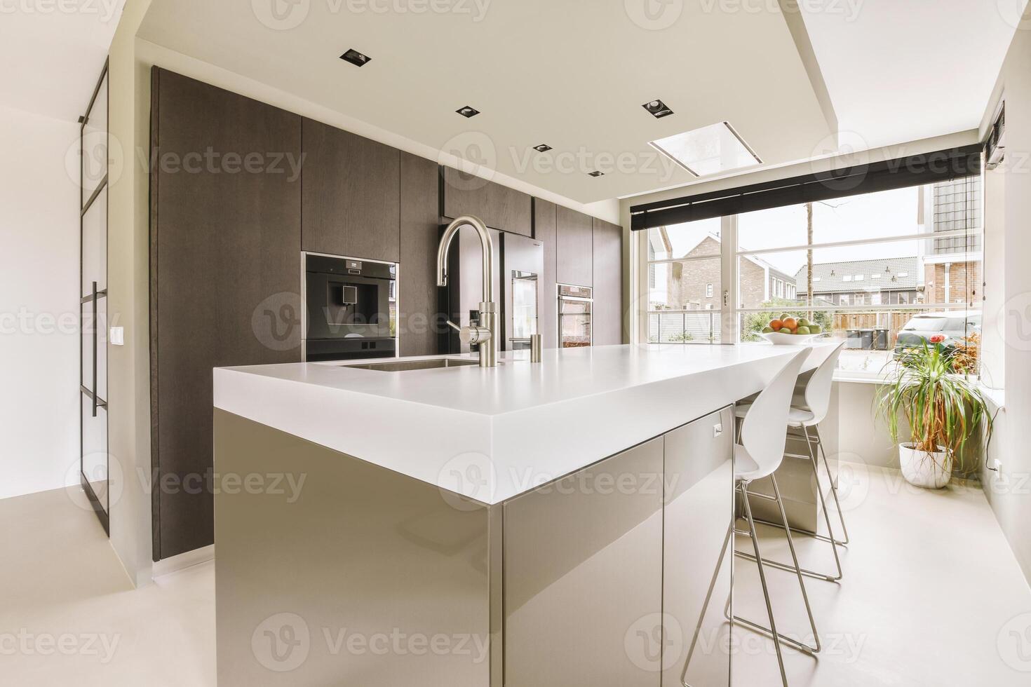 A kitchen with a large island and a window photo