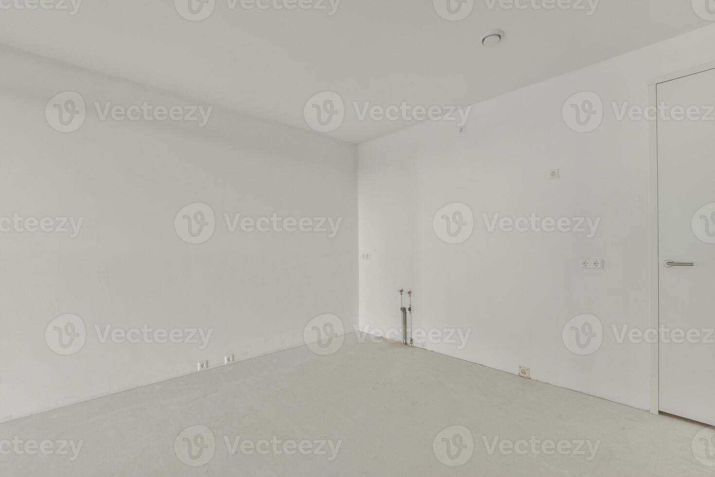 An empty room with white walls and a door photo