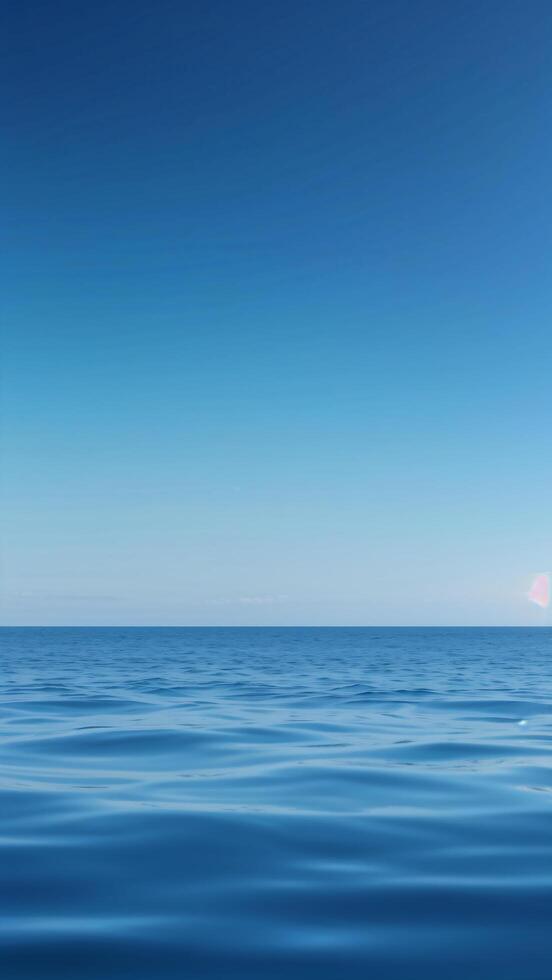 Calm Ocean Surface Reflecting a Clear Open Sky photo