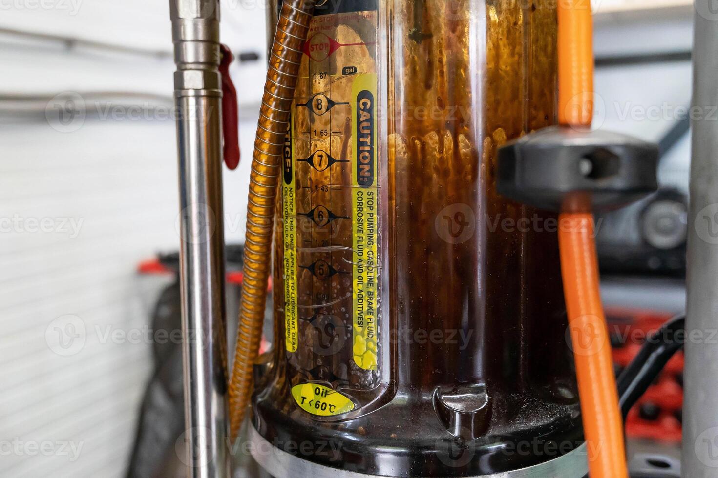 a container for vacuum pumping of used engine oil from a car engine photo