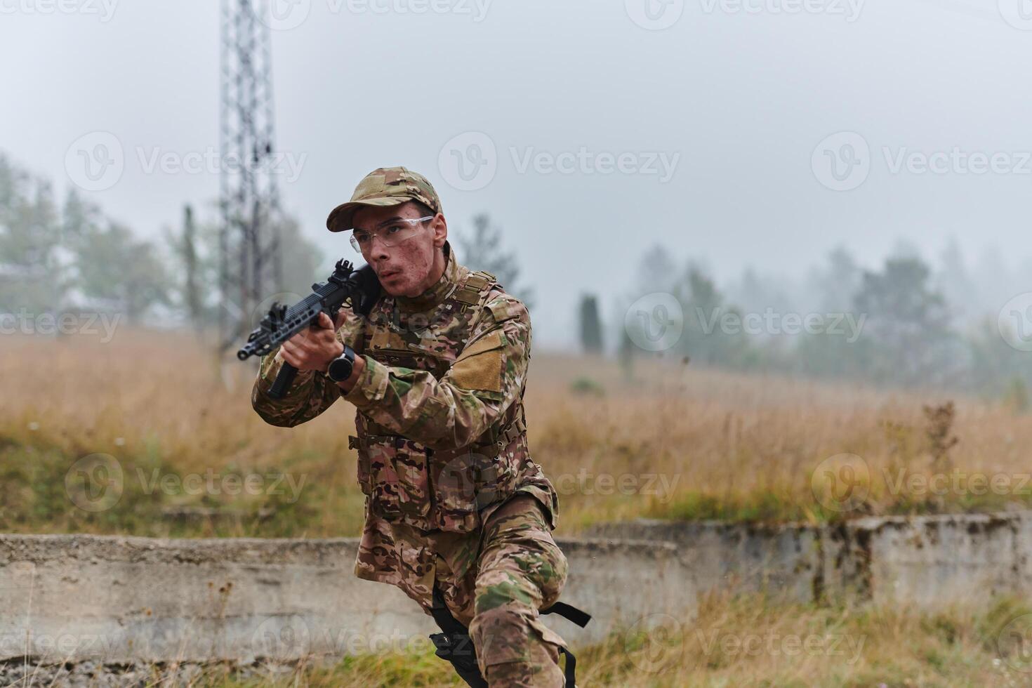 An elite soldier, camouflaged and stealthily navigating through dangerous woodland terrain, executes a covert mission in a secluded forest area photo