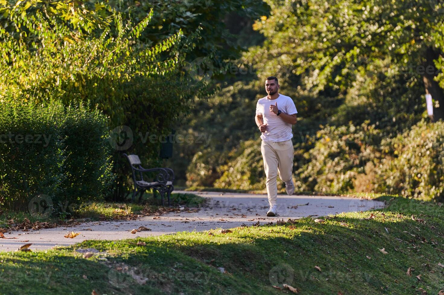 A handsome man maintains his healthy lifestyle as he runs along beautiful natural trails, embodying the essence of fitness, wellness, and vitality in the midst of scenic outdoor surroundings. photo