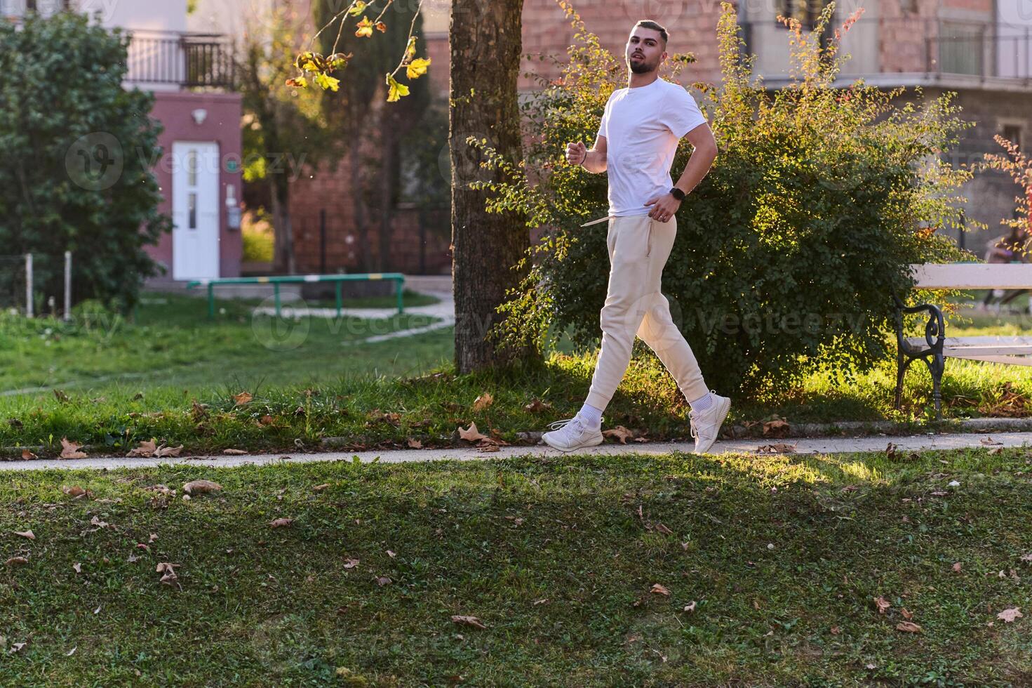 A handsome man maintains his healthy lifestyle as he runs along beautiful natural trails, embodying the essence of fitness, wellness, and vitality in the midst of scenic outdoor surroundings. photo