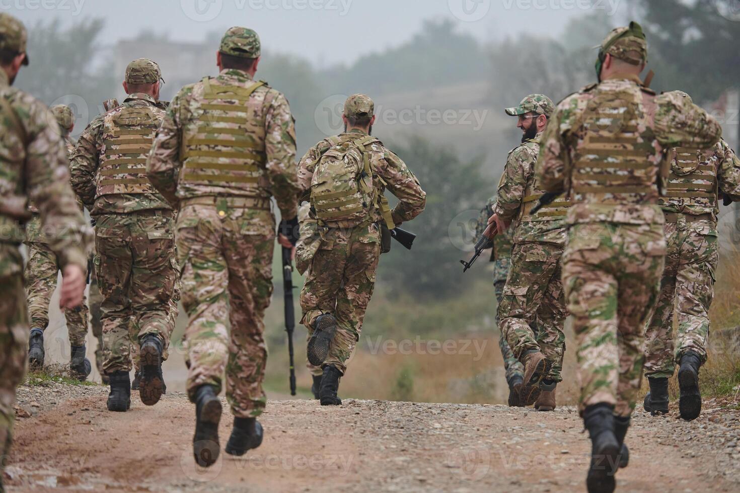 A disciplined and specialized military unit, donned in camouflage, strategically patrolling and maintaining control in a high-stakes environment, showcasing their precision, unity, and readiness for photo