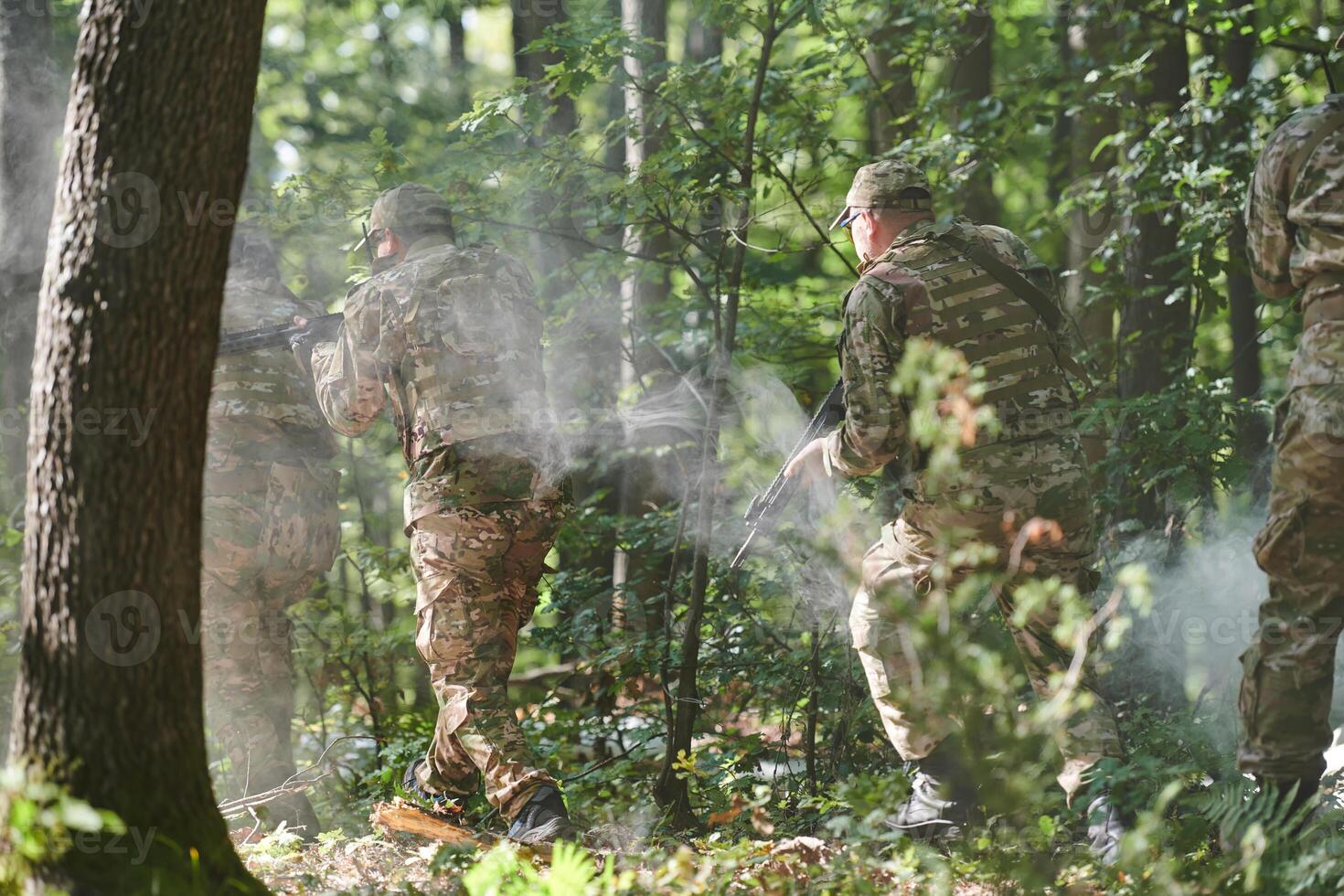 A specialized military antiterrorist unit conducts a covert operation in dense, hazardous woodland, demonstrating precision, discipline, and strategic readiness photo