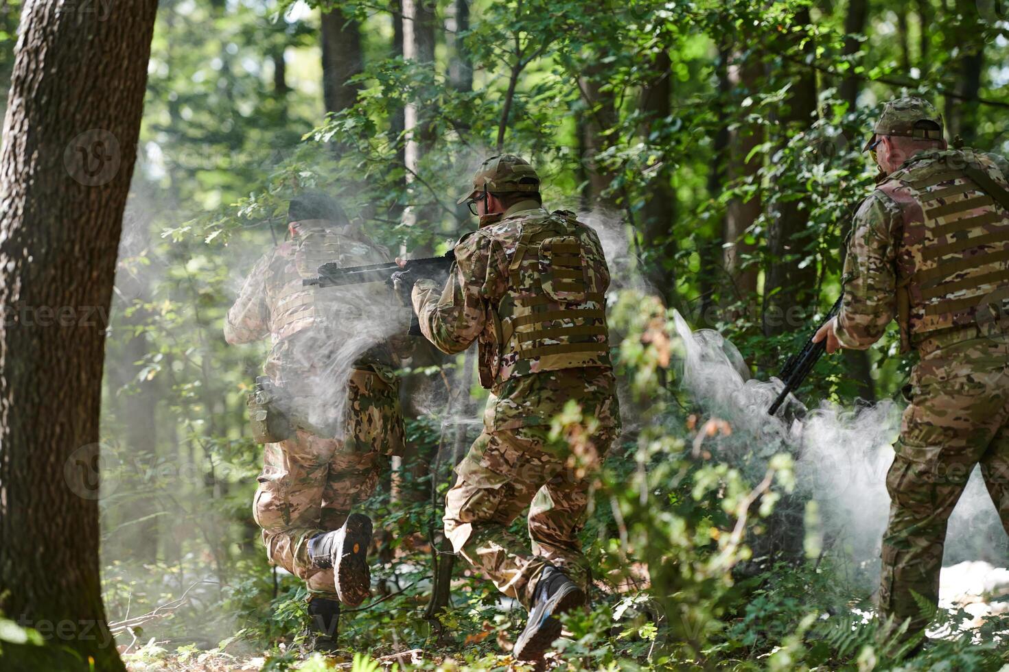 A specialized military antiterrorist unit conducts a covert operation in dense, hazardous woodland, demonstrating precision, discipline, and strategic readiness photo