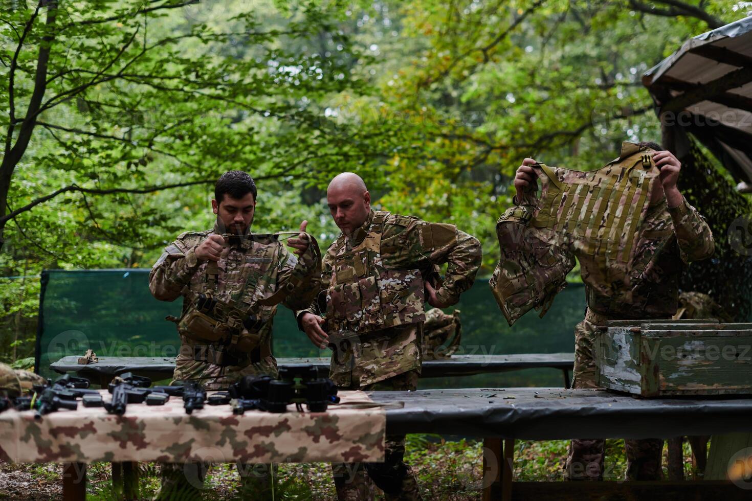 An elite military unit prepares for a hazardous forest operation, showcasing tactical prowess, camouflage skills, and strategic readiness photo
